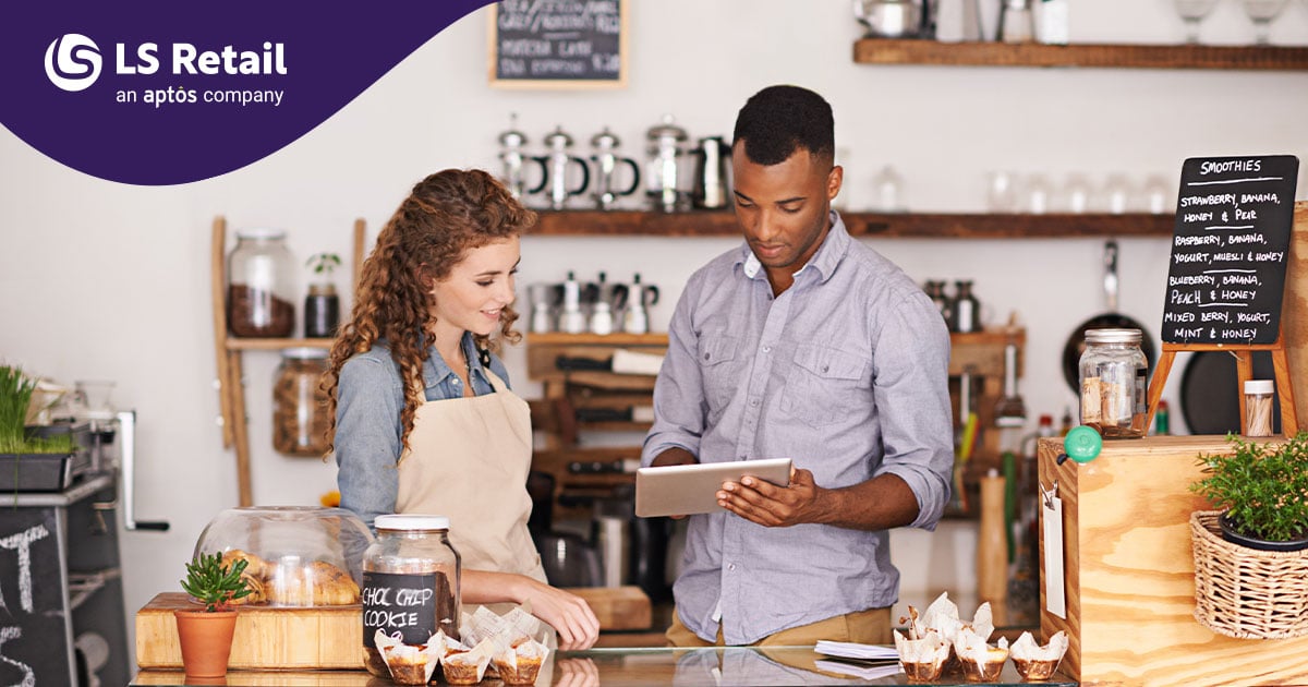 Man and woman looking at tablet at food counter